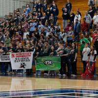 Participants in the fieldhouse waiting for medal ceremony